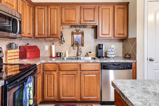 kitchen featuring tasteful backsplash, stainless steel appliances, and sink