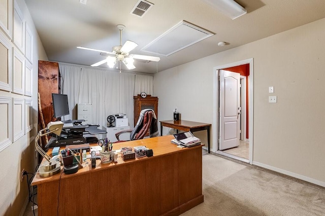 carpeted office featuring ceiling fan