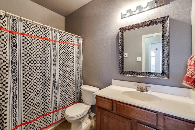 bathroom with vanity, toilet, and tile patterned flooring