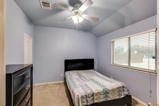 bedroom with ceiling fan, lofted ceiling, and light carpet