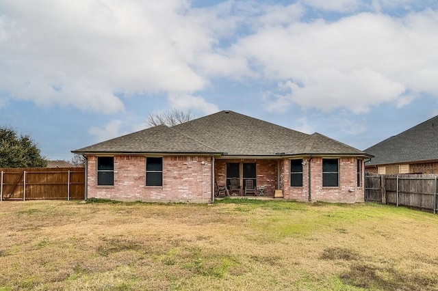 rear view of house with a lawn