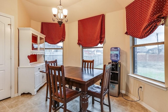 tiled dining area featuring an inviting chandelier