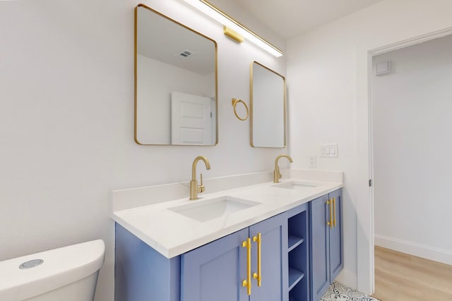 bathroom with vanity, hardwood / wood-style floors, and toilet