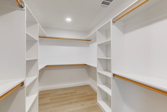 spacious closet featuring light hardwood / wood-style flooring