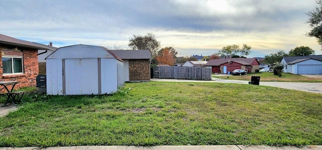 yard at dusk featuring a storage unit