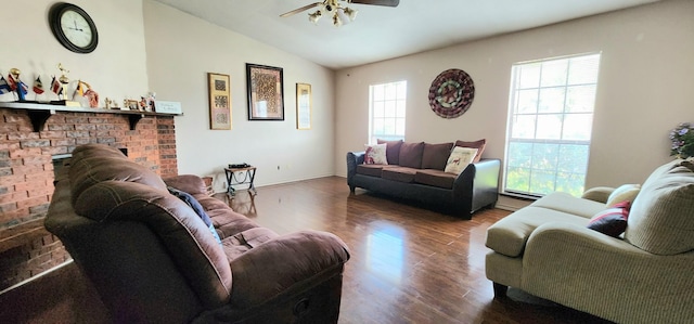 living room with ceiling fan, wood-type flooring, lofted ceiling, and a fireplace