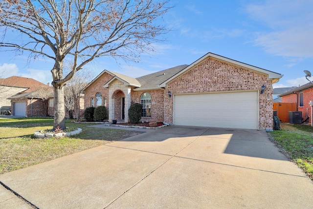 view of front of property featuring a front yard, central air condition unit, and a garage