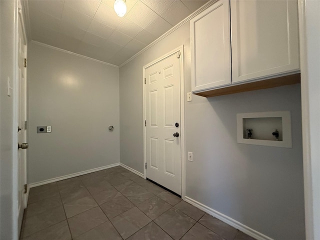 laundry room featuring crown molding, electric dryer hookup, cabinets, washer hookup, and dark tile patterned flooring