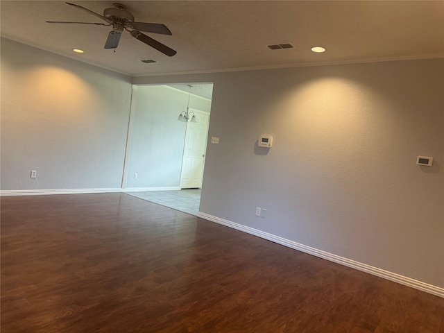 unfurnished room with ceiling fan, ornamental molding, and dark hardwood / wood-style floors