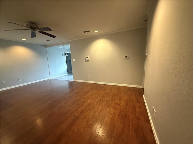 empty room featuring ornamental molding, dark hardwood / wood-style floors, and ceiling fan