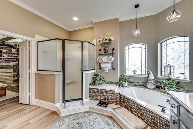 bathroom featuring a spacious closet, a tub with jets, crown molding, wood finished floors, and a stall shower