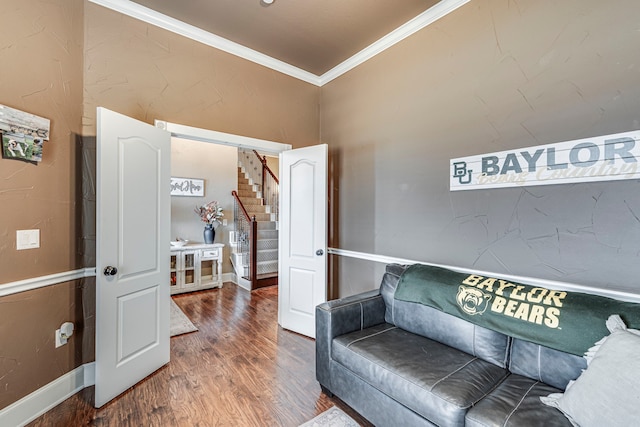 living area with crown molding and dark wood-type flooring