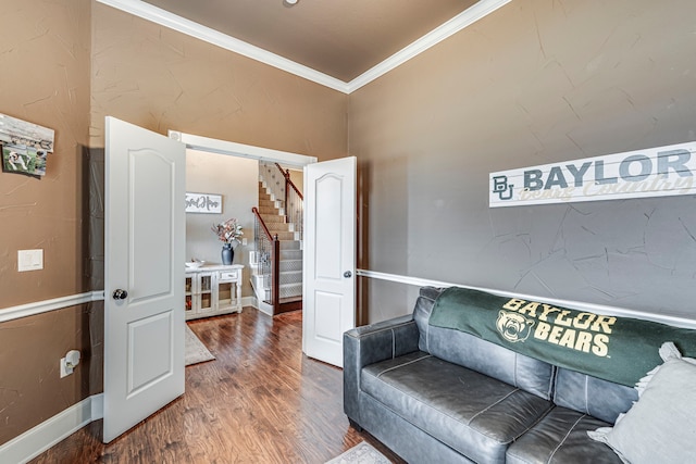 interior space featuring stairs, baseboards, crown molding, and wood finished floors