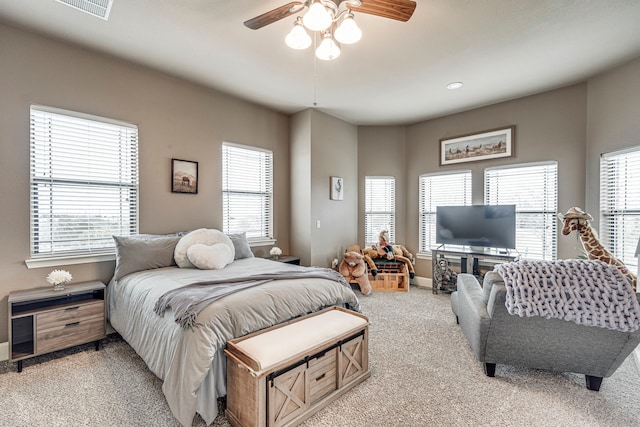 bedroom with visible vents, ceiling fan, light colored carpet, and baseboards