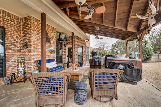 view of patio with an outdoor living space and ceiling fan