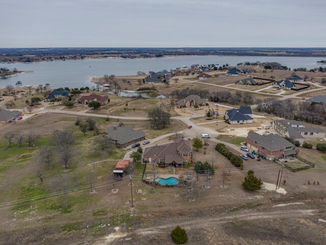 drone / aerial view with a water view and a residential view