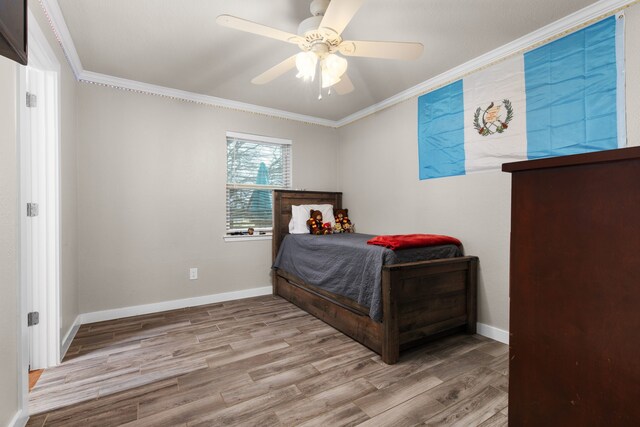 bedroom with ceiling fan, light hardwood / wood-style flooring, and crown molding