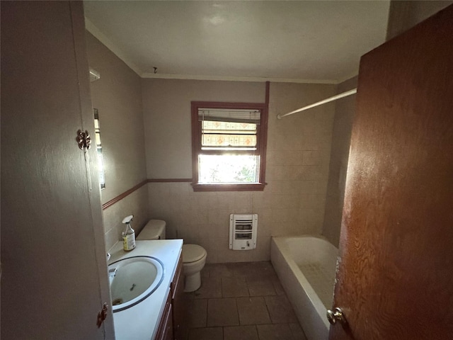 full bathroom with toilet, tile walls, heating unit, tile patterned floors, and vanity