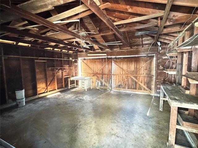 miscellaneous room with concrete flooring and lofted ceiling