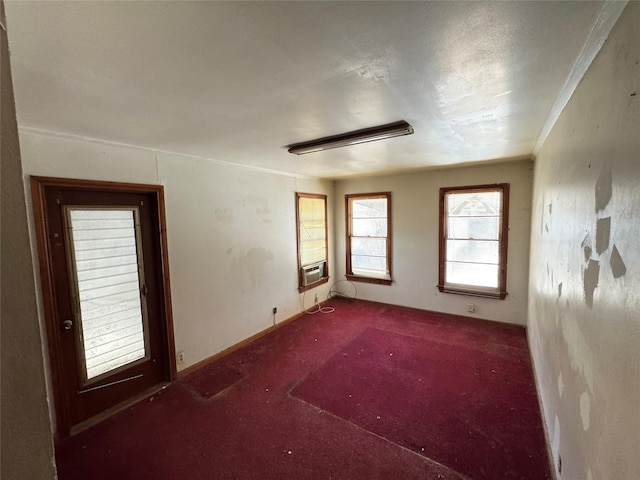 spare room featuring cooling unit and dark carpet