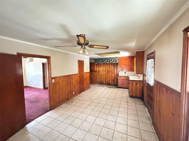 kitchen with sink, ceiling fan, crown molding, and light tile patterned floors