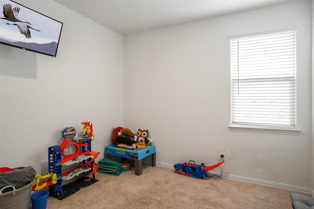 game room with plenty of natural light and light carpet