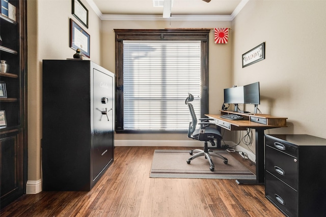 office with ornamental molding, visible vents, baseboards, and wood finished floors