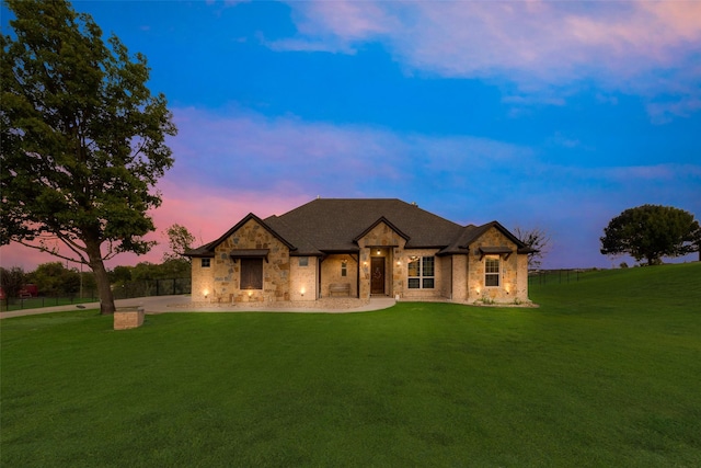 french country home with a front yard and fence