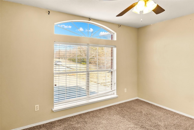 empty room featuring carpet floors and ceiling fan