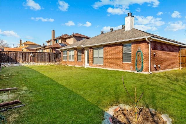 rear view of house with a lawn