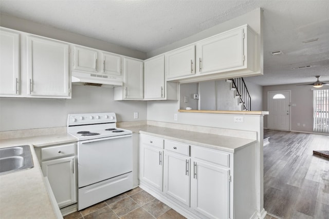 kitchen featuring white cabinets, a textured ceiling, ceiling fan, and electric stove