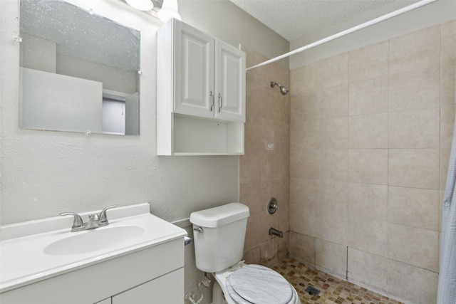 bathroom with a textured ceiling, toilet, vanity, and a shower with shower curtain