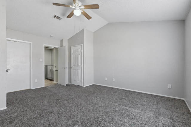 unfurnished bedroom featuring ceiling fan, dark carpet, and lofted ceiling