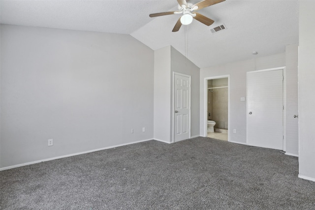 unfurnished bedroom with ceiling fan, carpet, lofted ceiling, and ensuite bath