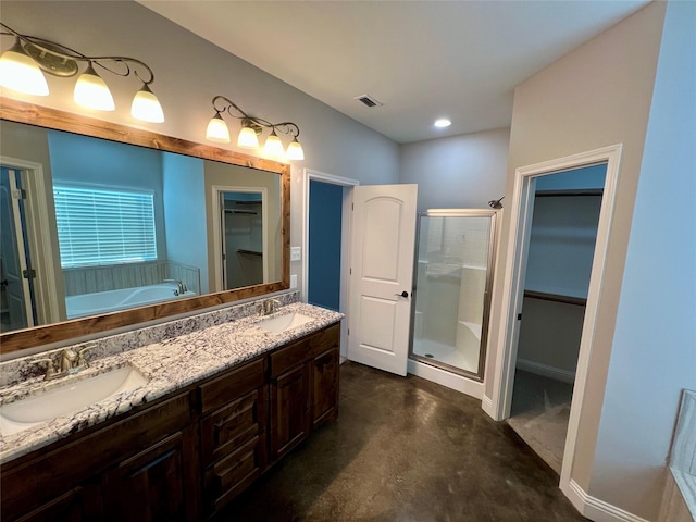 bathroom featuring vanity, concrete flooring, and separate shower and tub