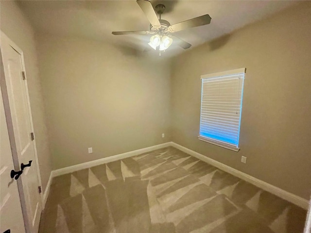 empty room featuring carpet floors and ceiling fan