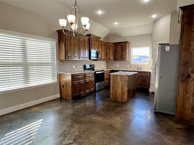 kitchen with appliances with stainless steel finishes, lofted ceiling, backsplash, hanging light fixtures, and a center island