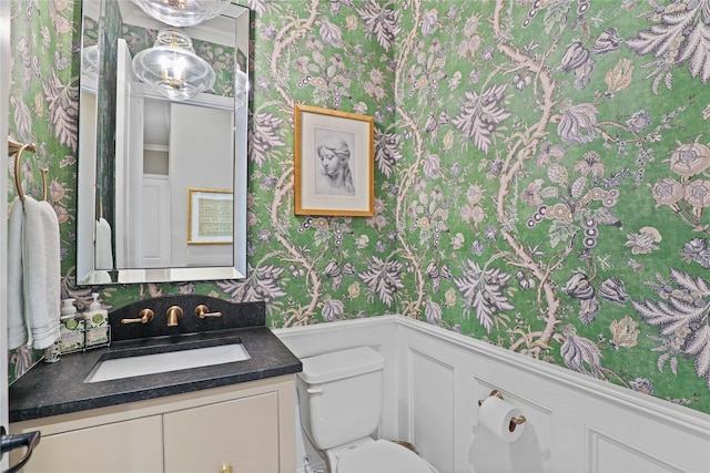 bathroom featuring vanity and toilet