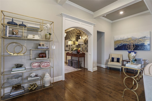 sitting room featuring ornamental molding, beamed ceiling, and dark hardwood / wood-style flooring