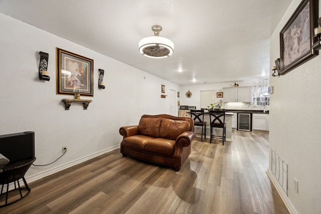 living room with hardwood / wood-style floors and beverage cooler