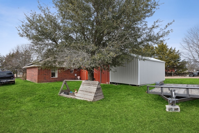 rear view of property featuring an outbuilding and a yard