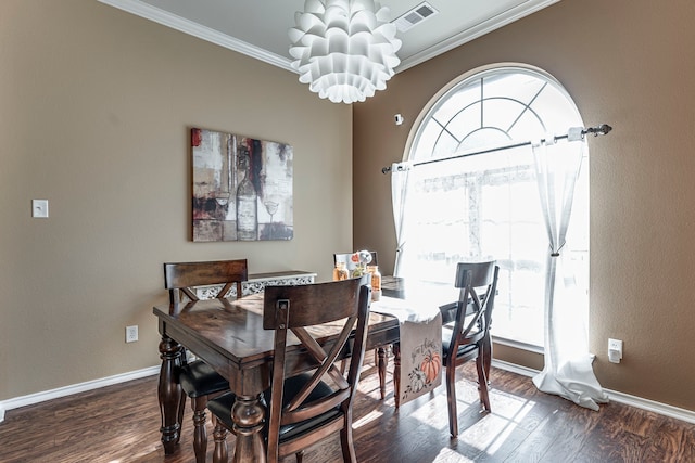 dining area featuring a notable chandelier, ornamental molding, and dark hardwood / wood-style flooring