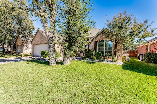 view of front of home featuring a garage and a front yard