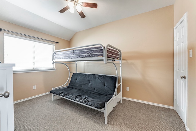 carpeted bedroom with vaulted ceiling and ceiling fan