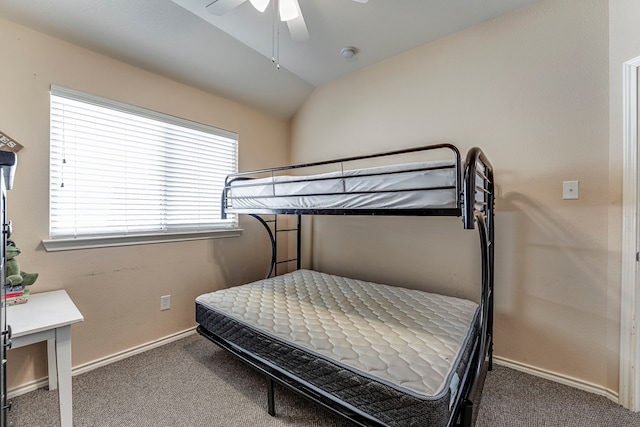 carpeted bedroom with vaulted ceiling and ceiling fan