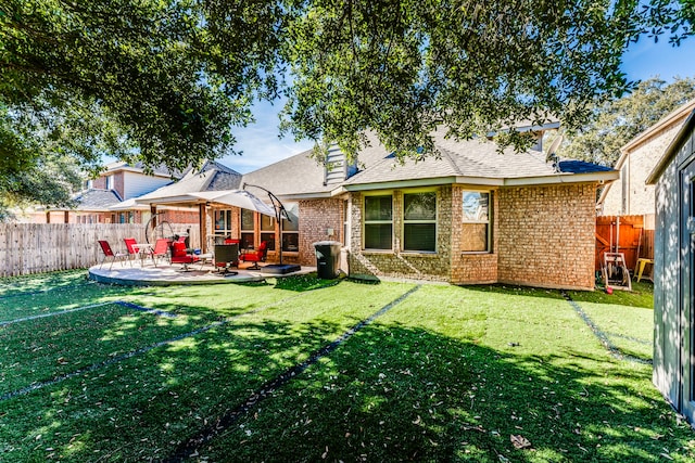 rear view of property with a patio area and a yard