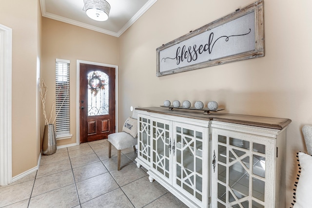 entrance foyer with light tile patterned floors and ornamental molding