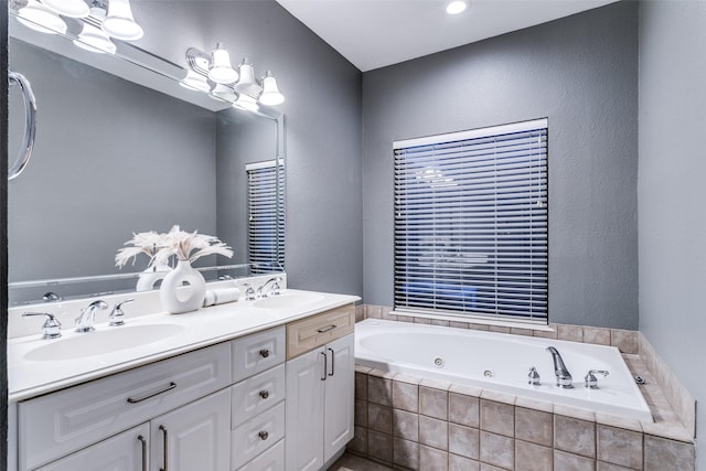 bathroom featuring vanity and tiled bath