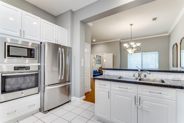 kitchen with light tile patterned floors, sink, white cabinets, and stainless steel appliances