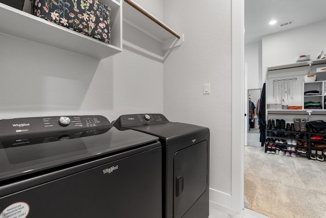 washroom featuring independent washer and dryer and light carpet